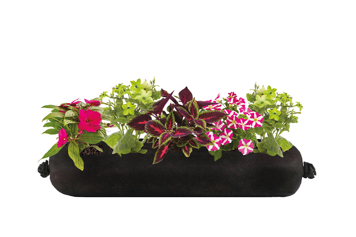 An artificial floral arrangement of a variety of flowers in a black container.