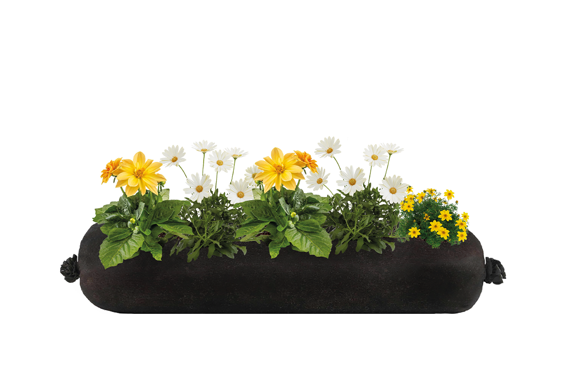 An artificial floral arrangement of a variety of flowers in a black container.