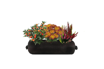 Black fabric planter with colorful flowers on a white background