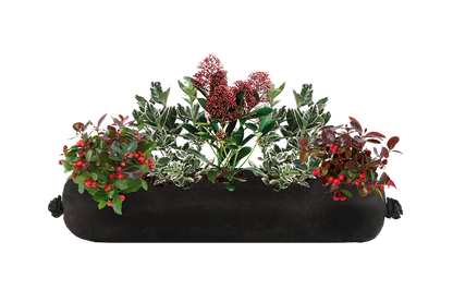 Decorative planter with greenery and red berries on a white background