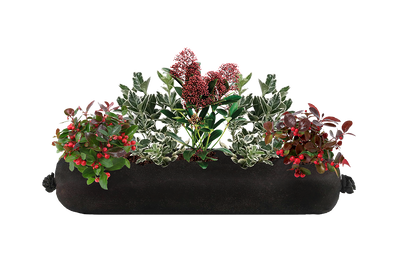 Decorative planter with greenery and red berries on a white background