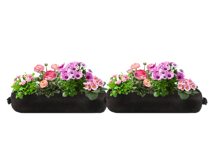 A pair of two black fabric planter inserts with pink flowers on a white background.