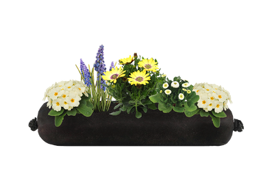 Decorative white, yellow and purple flower arrangement in a black fabric planter insert on a white background
