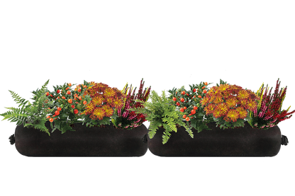 Two black fabric planters with floral arrangements on a white background