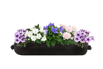 Floral arrangement in a black planter against a white background