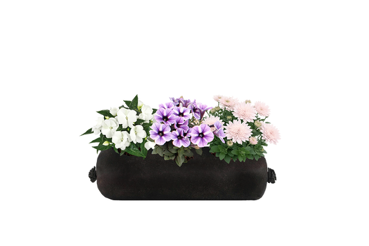 Black fabric planter with colorful flowers on a white background