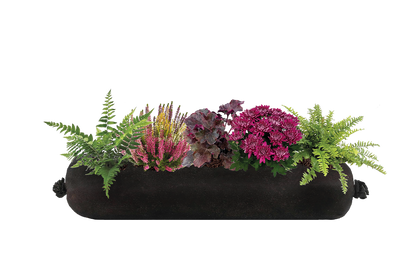 Black fabric planter with assorted plants on a white background
